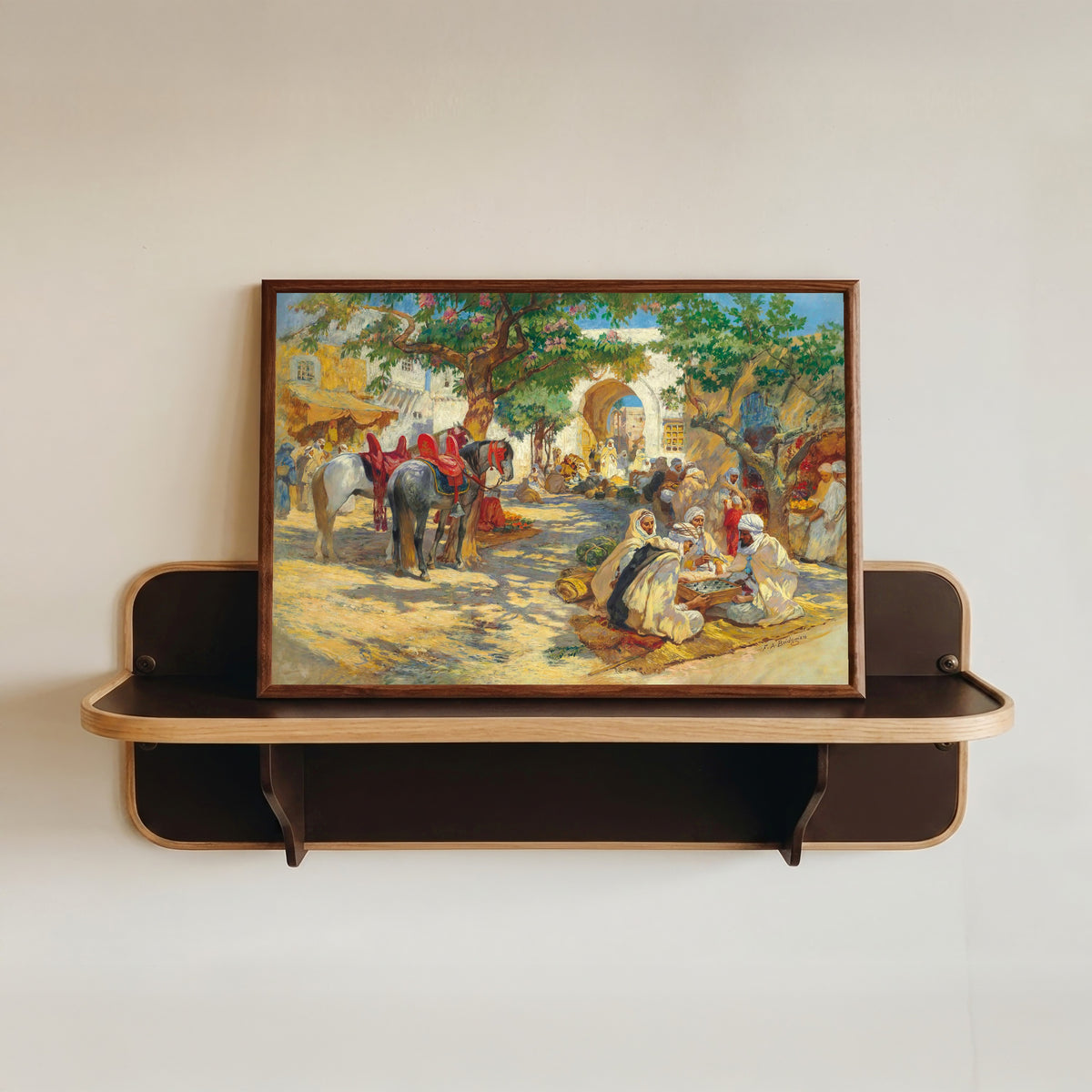 Framed art print of Chess Players, Biskra by Frederick Arthur Bridgman, in a dark wood frame resting on a wall shelf