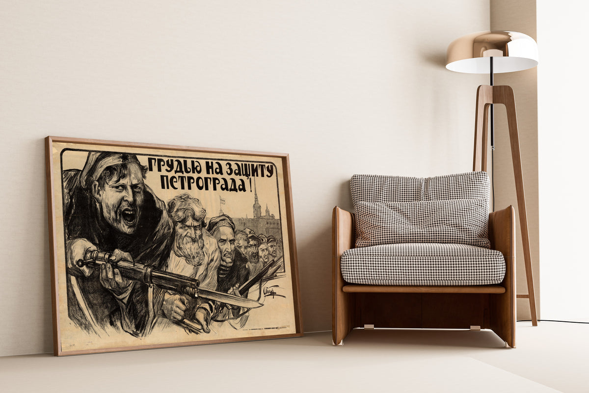 Framed art print of Chest Forward to Defend Petrograd! by Alexander Apsit, leaning against a wall beside an armchair and a floor lamp