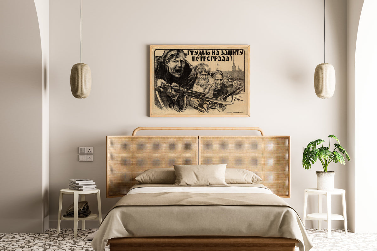 Framed art print of Chest Forward to Defend Petrograd! by Alexander Apsit, above a cane-headboard bed
