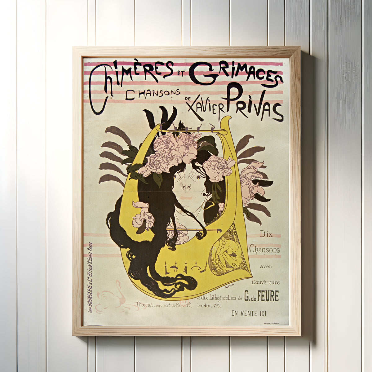 Framed art print of Chimères et Grimaces: Chansons de Xavier Privas by Georges de Feure, in a light wood frame on a white panelled wall