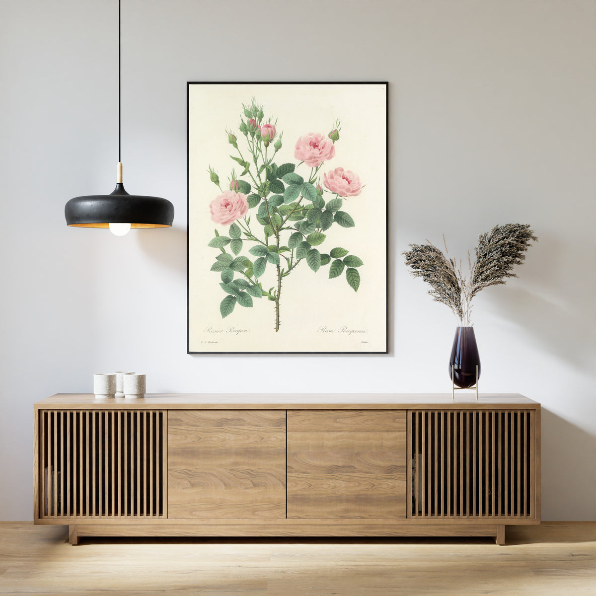 Framed art print of Choix des plus belles fleurs, Plate 101: Rosa Pomponia by Pierre-Joseph Redouté, above a slatted wood sideboard