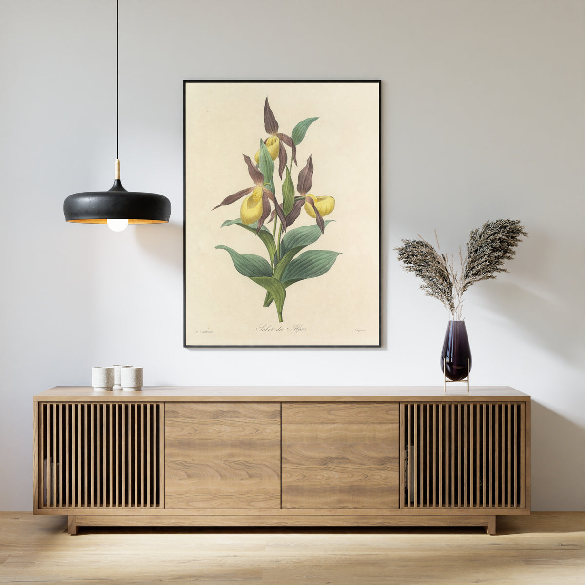 Framed art print of Choix des plus belles fleurs, Plate 102: Sabot des Alpes by Pierre-Joseph Redouté, above a slatted wood sideboard