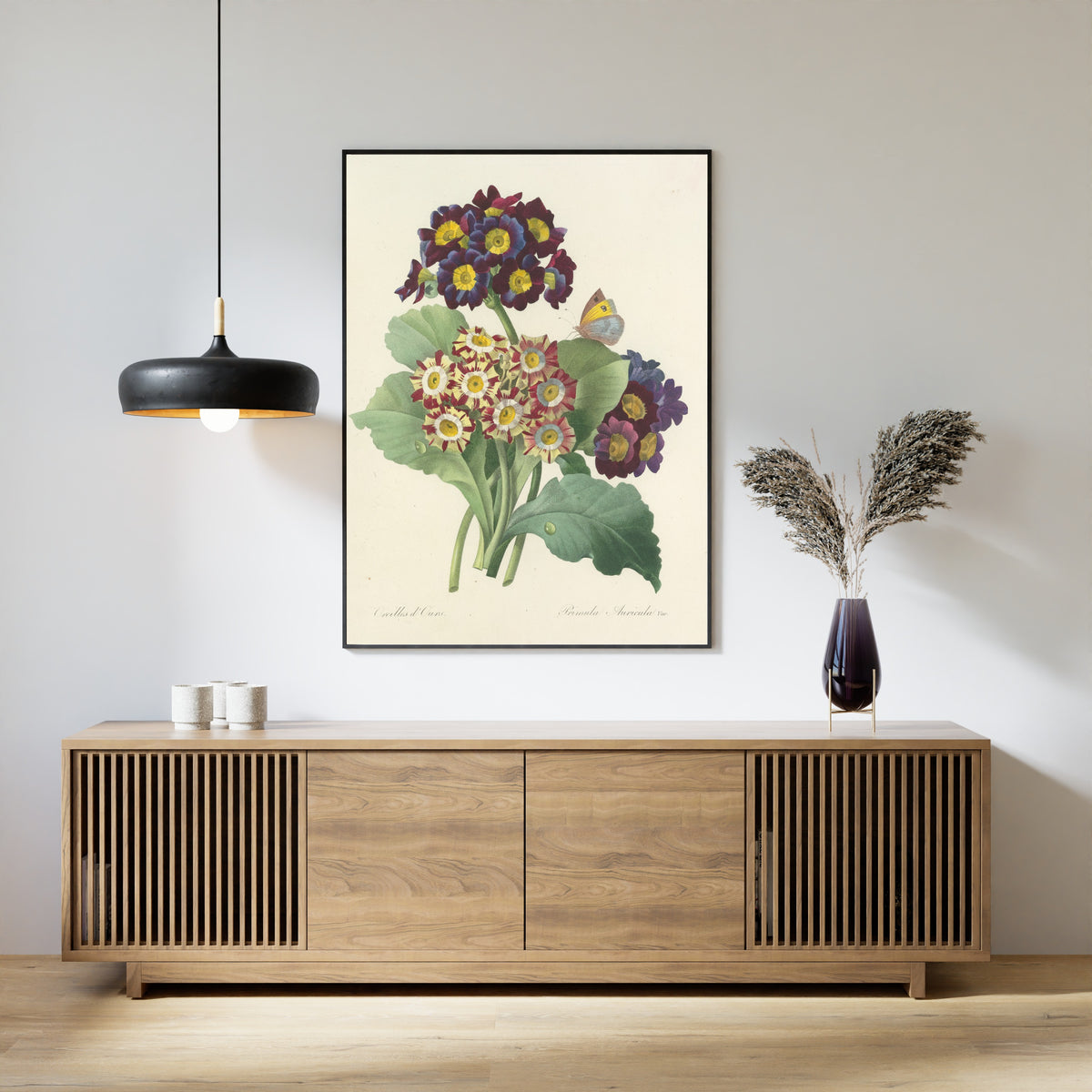 Framed art print of Choix des plus belles fleurs, Plate 80: Primula Auricula Var. by Pierre-Joseph Redouté, above a slatted wood sideboard