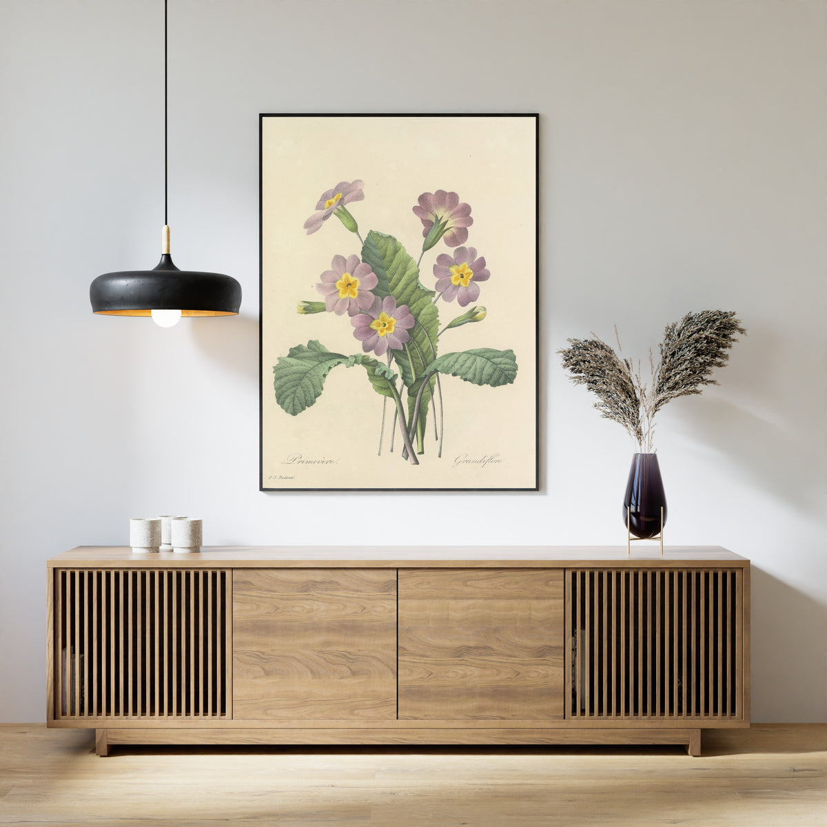 Framed art print of Choix des plus belles fleurs, Plate 82: Primevère Grandiflore by Pierre-Joseph Redouté, above a slatted wood sideboard