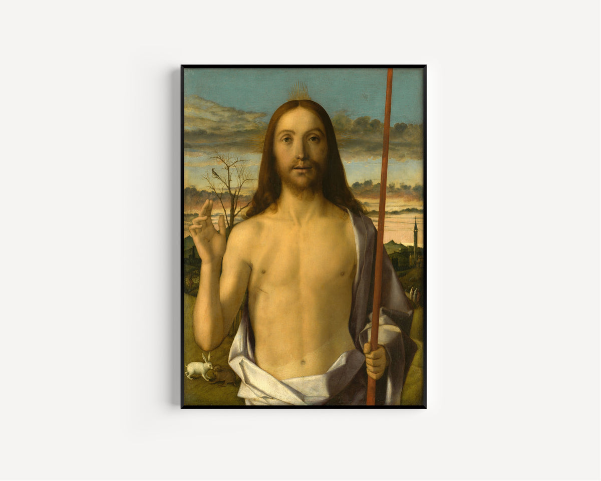 Framed art print of Christ Blessing by Giovanni Bellini, in a slim black frame on a plain white wall