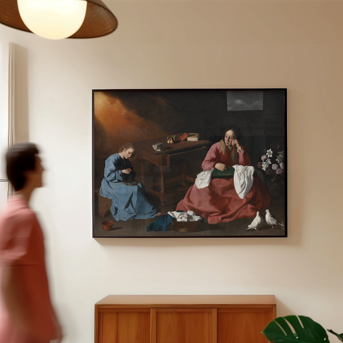 Framed art print of Christ and the Virgin in the House at Nazareth by Francisco de Zurbarán, in a slim black frame on a warm wall in a sunlit room