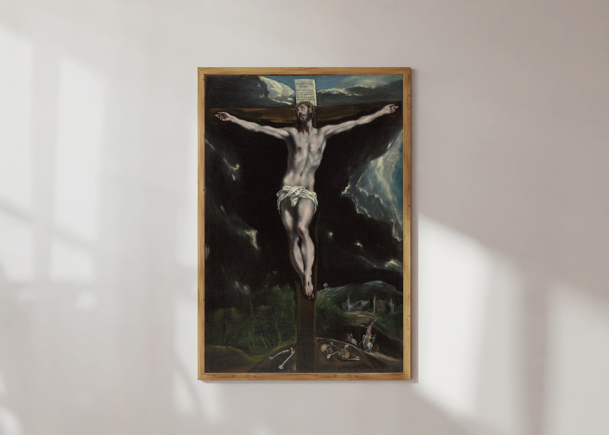 Framed art print of Christ on the Cross by El Greco, in a light wood frame on a sunlit white wall