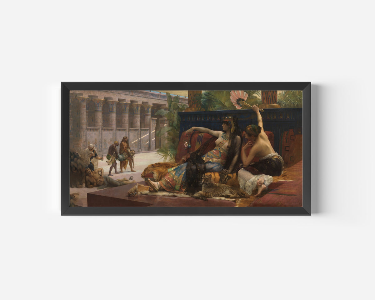 Framed art print of Cleopatra Testing Poisons on Condemned Prisoners by Alexandre Cabanel, in a wide black frame on a plain white wall