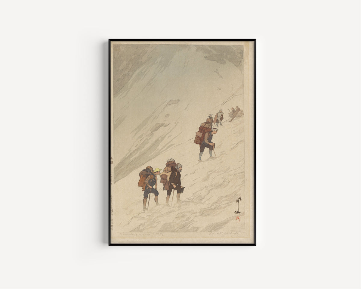 Framed art print of Climbing a Snow Valley at Harinoki by Hiroshi Yoshida, in a slim black frame on a plain white wall