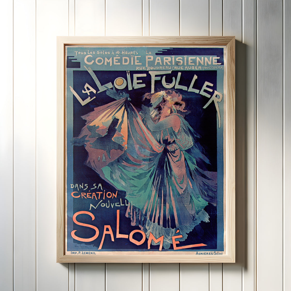 Framed art print of Comédie Parisienne: La Loïe Fuller dans sa création nouvelle, Salomé by Georges de Feure, in a light wood frame on a white panelled wall