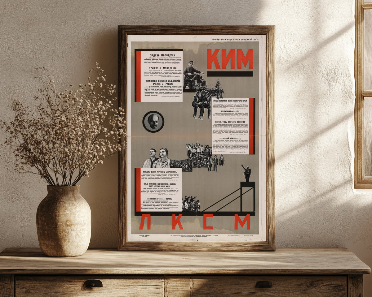 Framed art print of Communist Youth International and the Young Communist League…, in a dark wood frame leaning on a rustic console beside dried flowers
