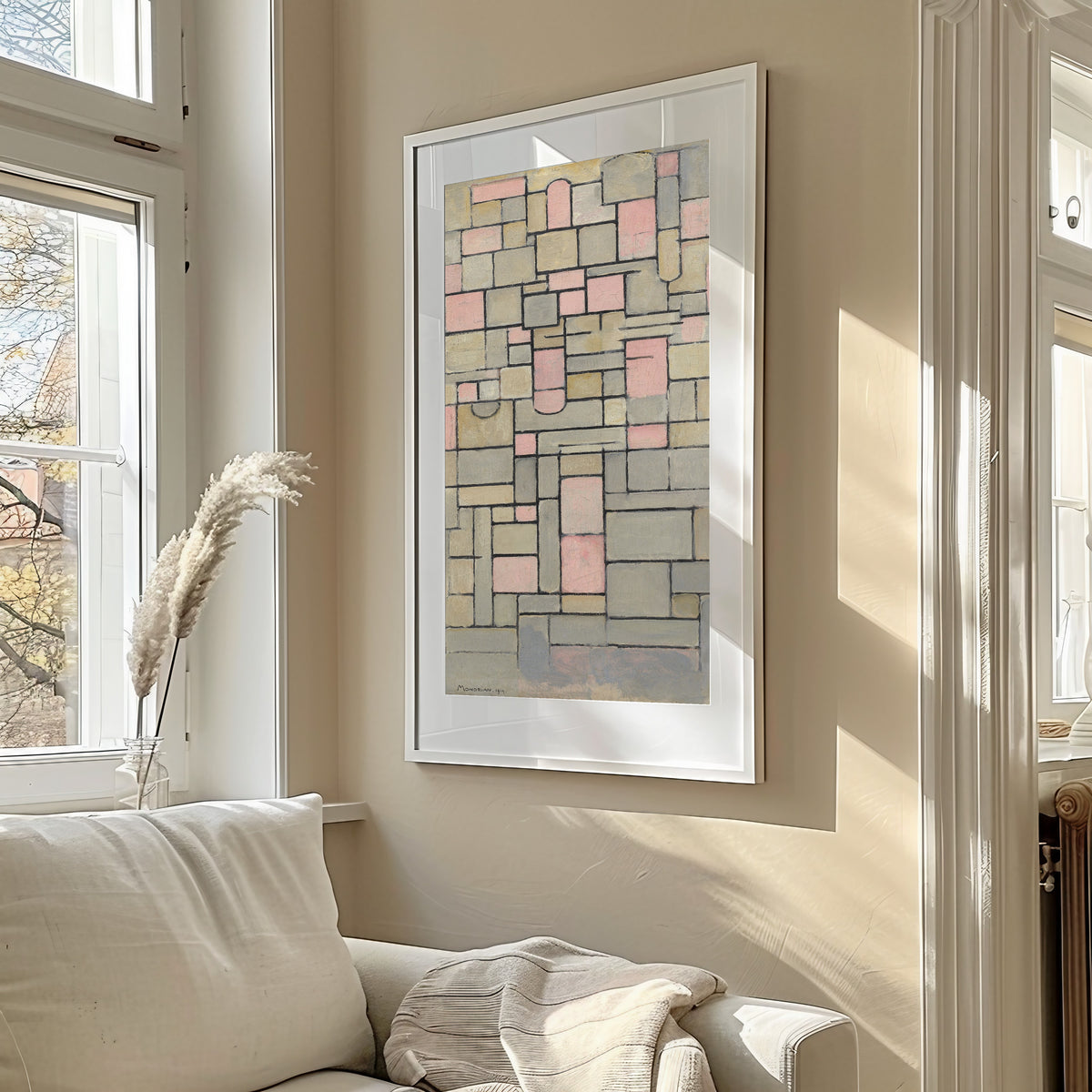 Framed art print of Composition 8 by Piet Mondrian, in a sunlit living room above a sofa