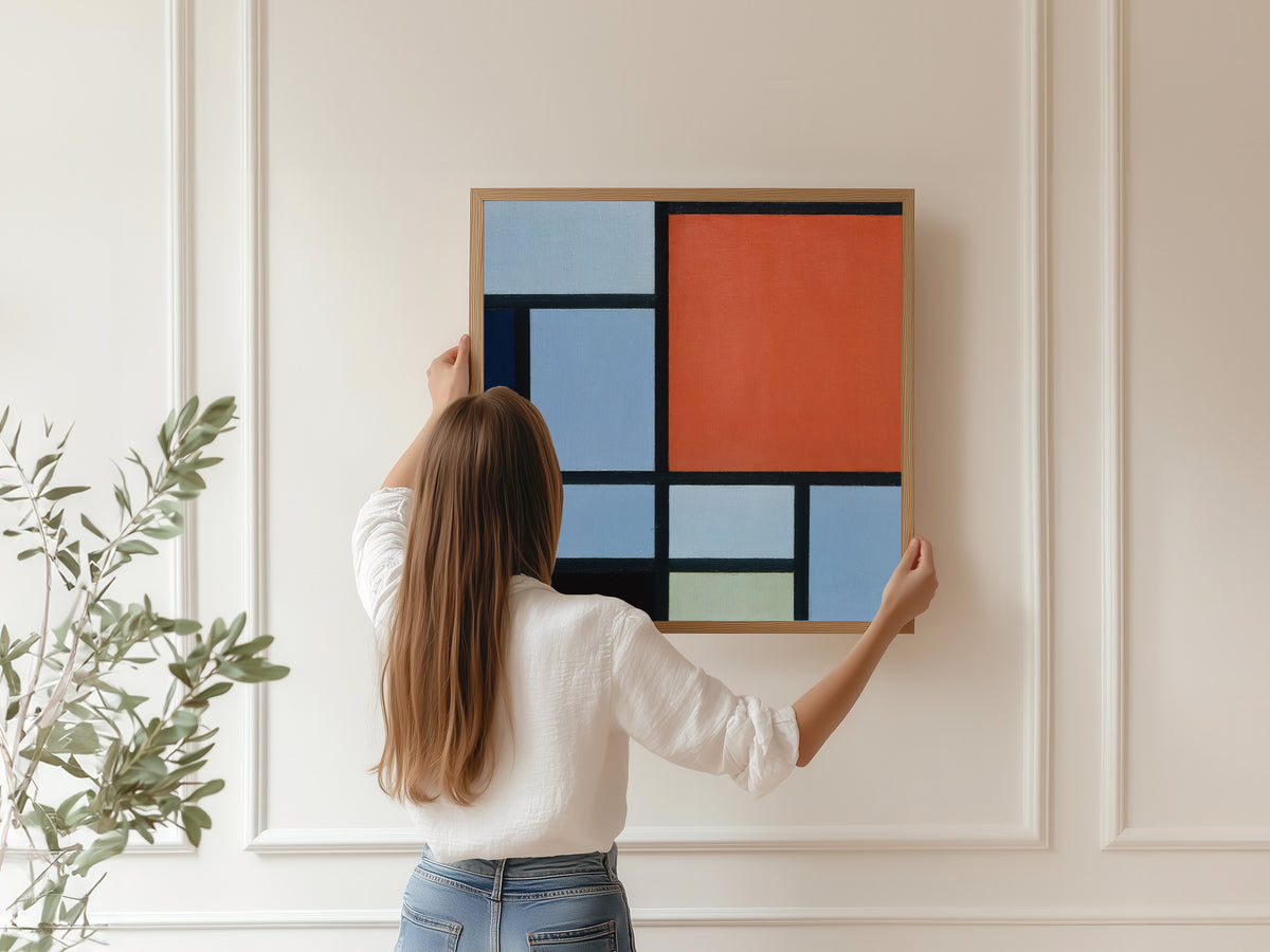 Framed art print of Composition (Red and Grey-Blue) by Piet Mondrian, hung on a panelled wall