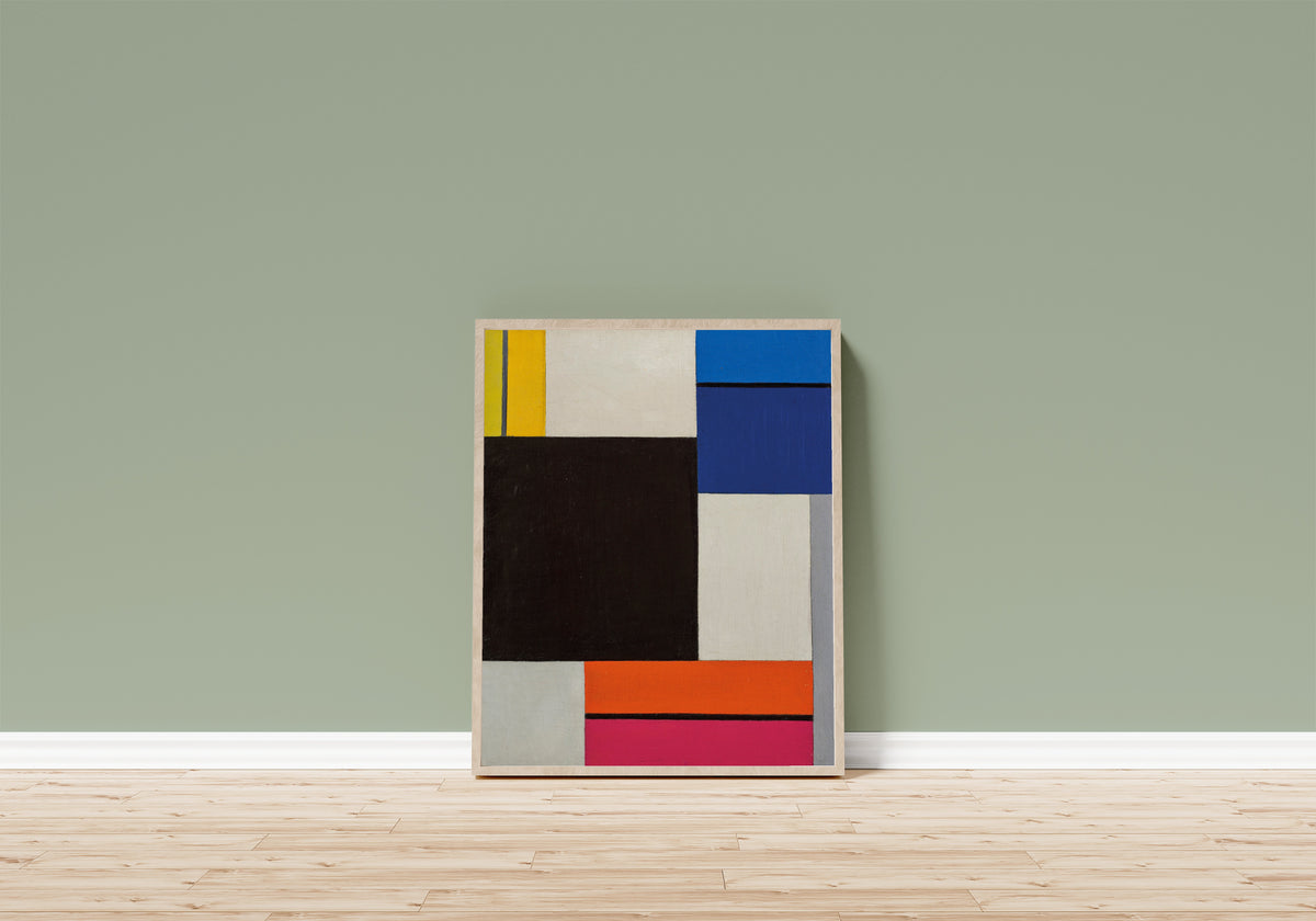 Framed art print of Composition XXI by Theo van Doesburg, in a light wood frame leaning on a sage green wall above a wooden floor