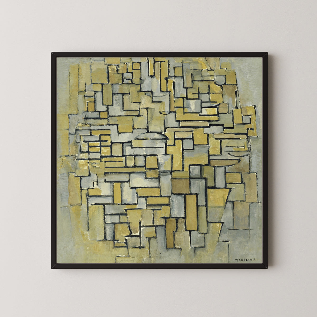 Framed art print of Composition in Brown and Grey by Piet Mondrian, in a black frame on a pale wall