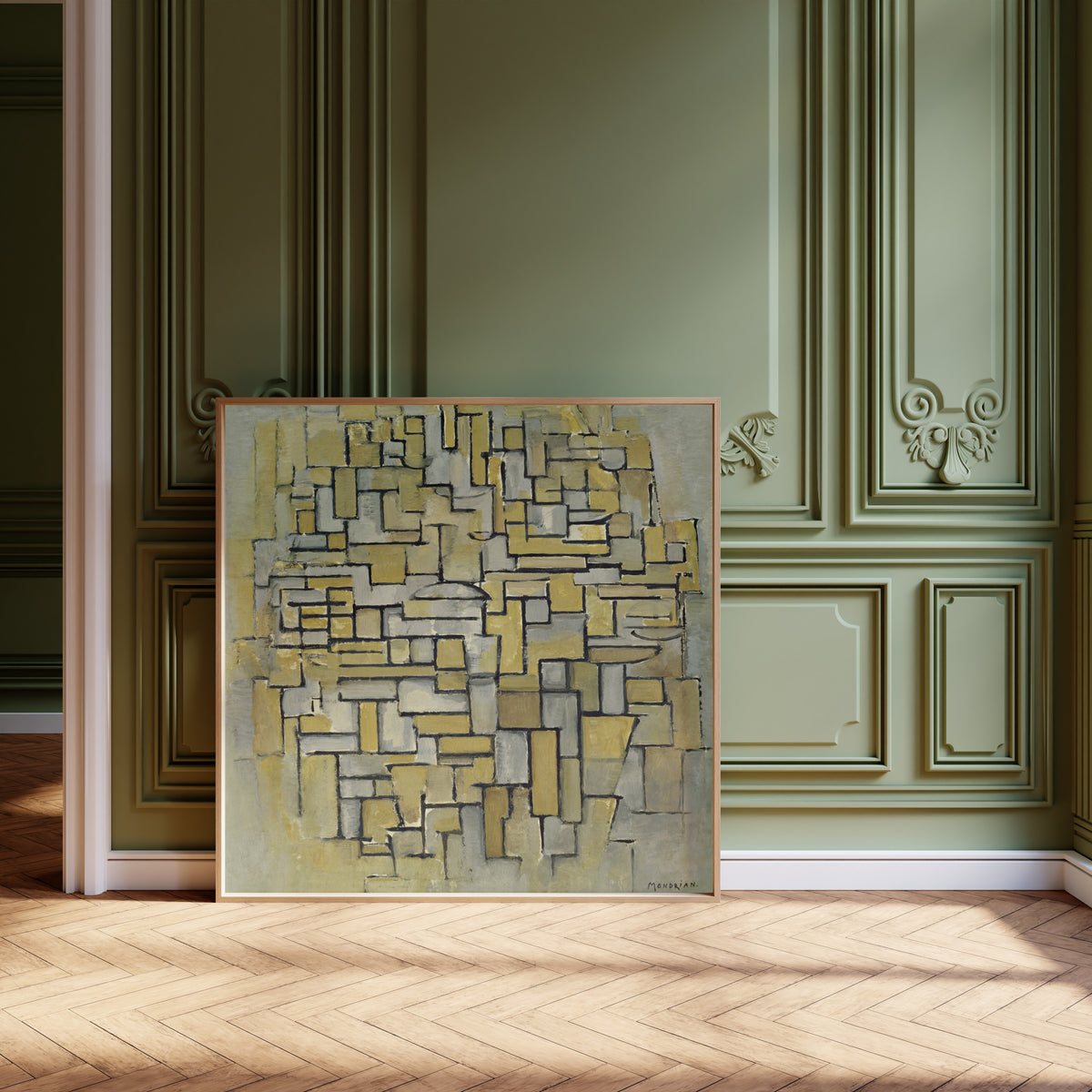 Framed art print of Composition in Brown and Grey by Piet Mondrian, leaning against olive-green panelling on a herringbone floor