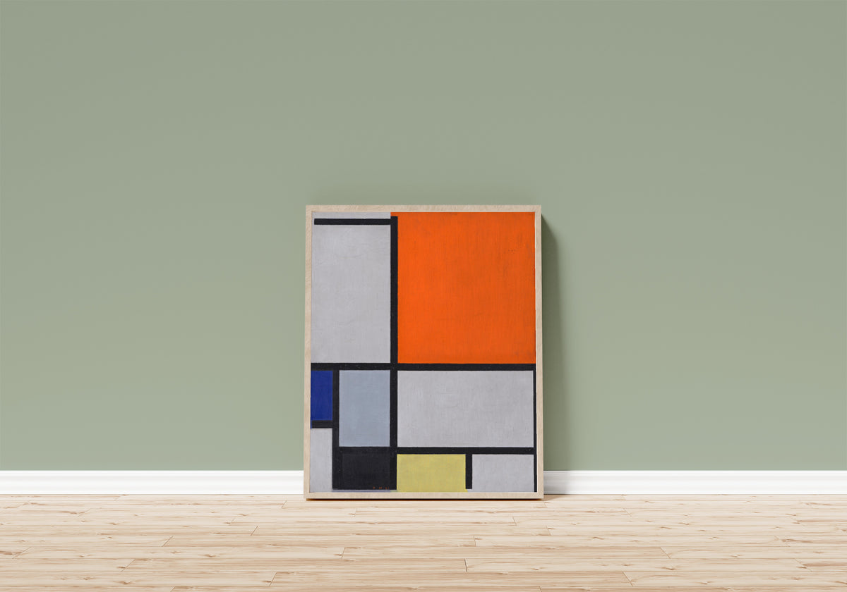 Framed art print of Composition with Large Red Plane, Blue, Gray… by Piet Mondrian, in a light wood frame leaning on a sage green wall above a wooden floor