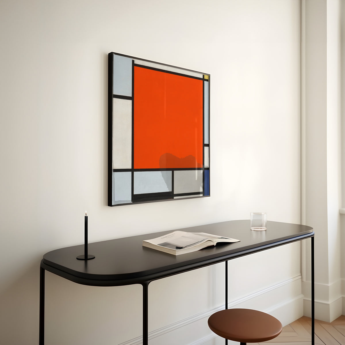 Framed art print of Composition with Large Red Plane, Bluish Gray, Yellow, Black and Blue by Piet Mondrian, above a slim black console table