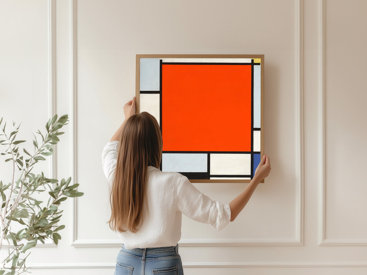 Framed art print of Composition with Large Red Plane, Bluish Gray, Yellow, Black and Blue by Piet Mondrian, hung on a panelled wall