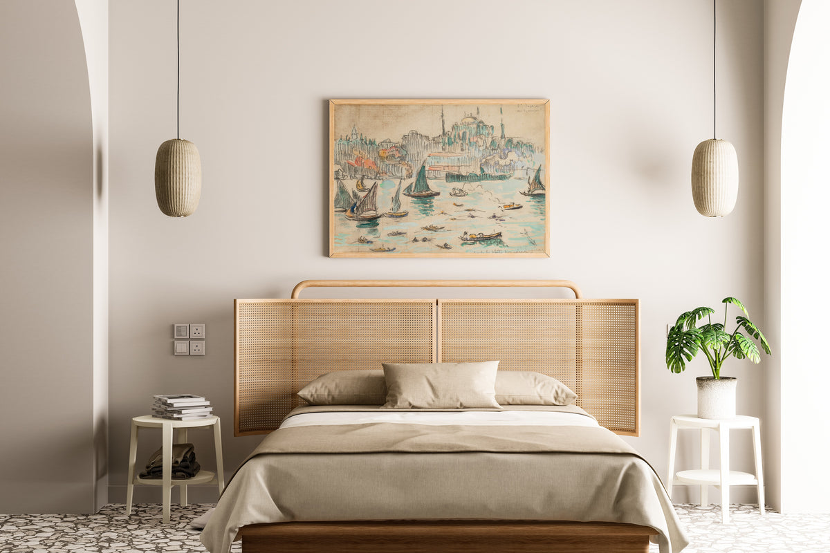 Framed art print of Constantinople, Sainte-Sophie by Paul Signac, above a cane-headboard bed