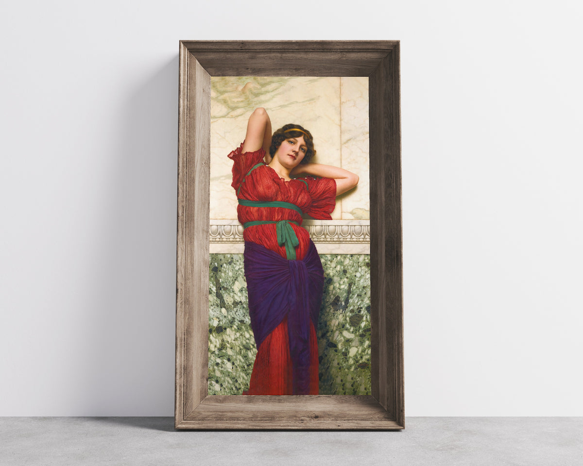 Framed art print of Contemplation by John William Godward, in a wide wooden frame leaning against a concrete wall