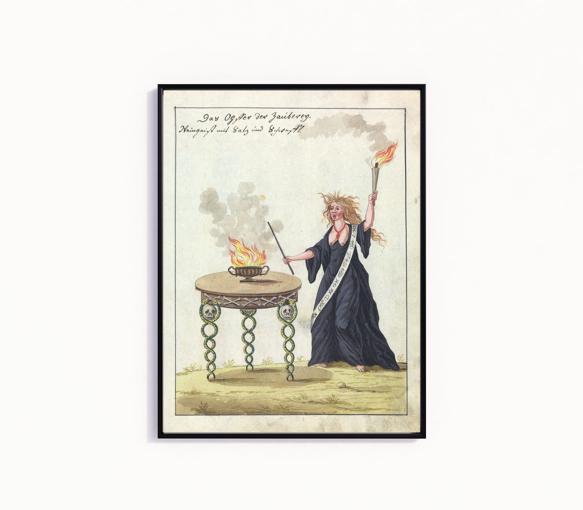 Framed art print of Das Opfer der Zauberey by Unknown artist, in a slim black frame on a plain white wall