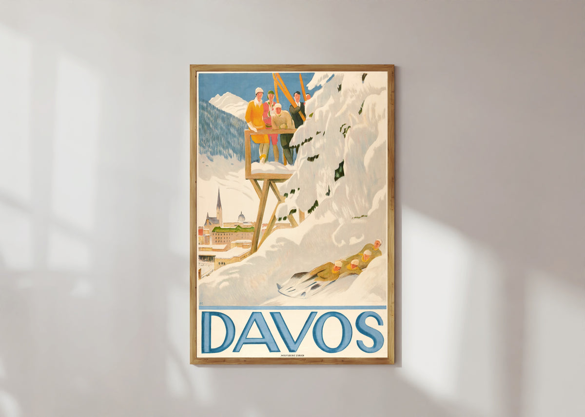 Framed art print of Davos by Emil Cardinaux, in a light wood frame on a sunlit white wall