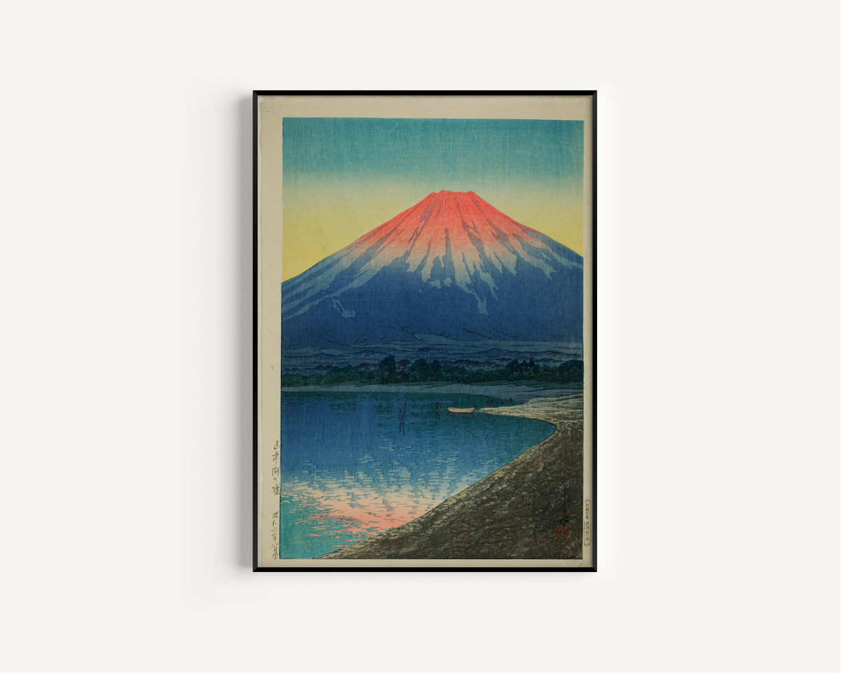 Framed art print of Daybreak over Lake Yamanaka by Kawase Hasui, in a slim black frame on a plain white wall