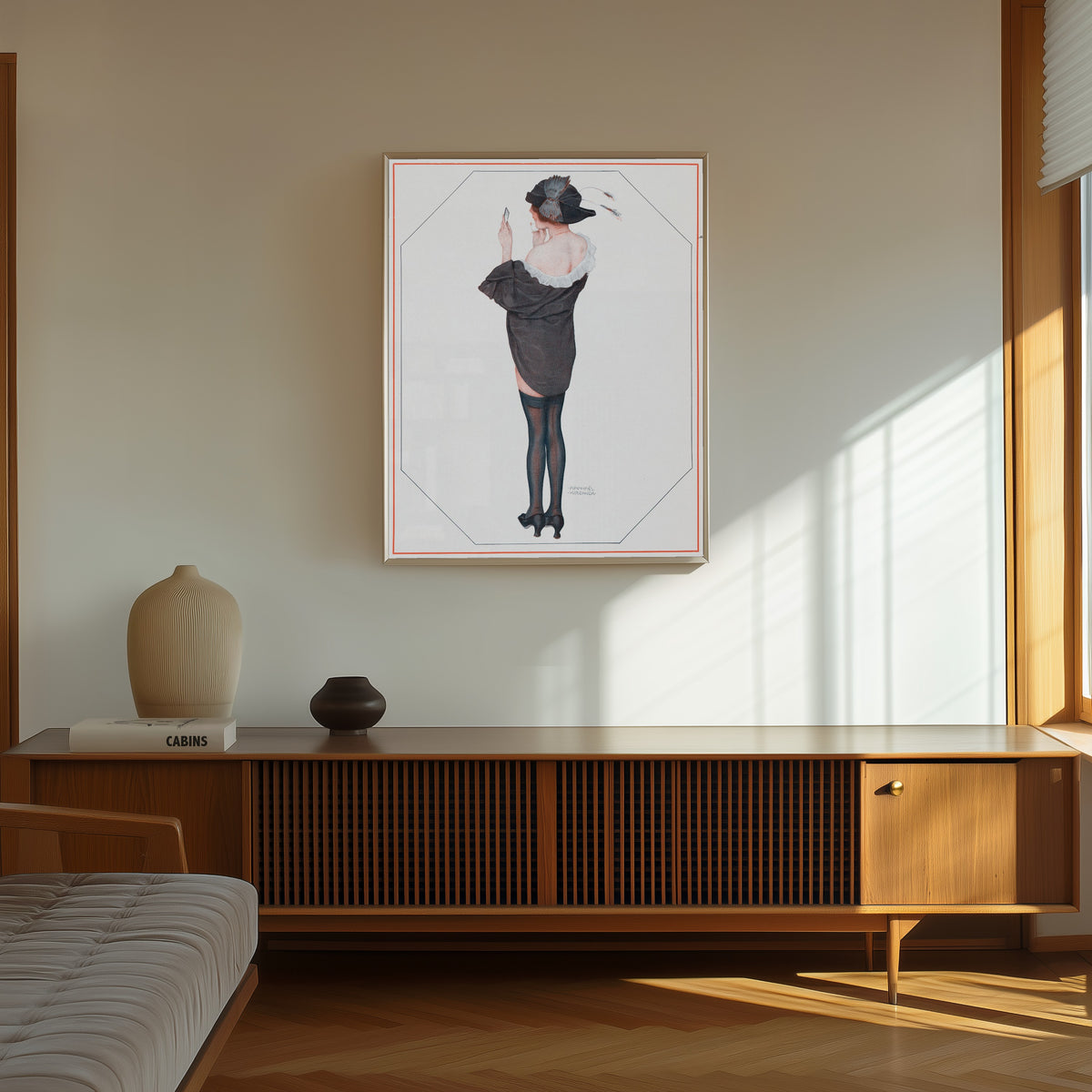 Framed art print of De la Brune à la Blonde, Pl. 2: Entre Deux Poses by Raphael Kirchner, in a thin light frame on a sunlit wall above a wooden sideboard