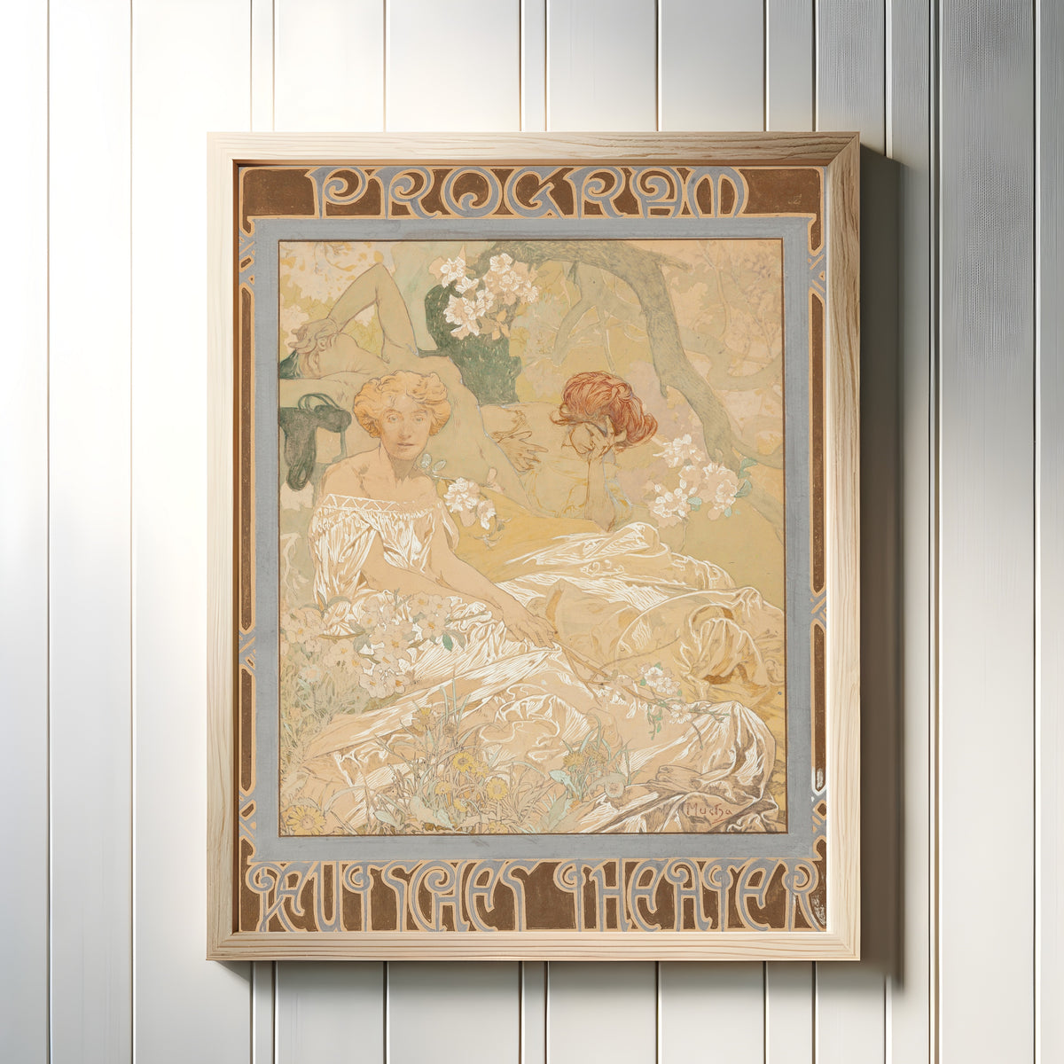 Framed art print of Deutsches Schauspiel-Haus, Theater Program by Alphonse Mucha, in a light wood frame on a white panelled wall