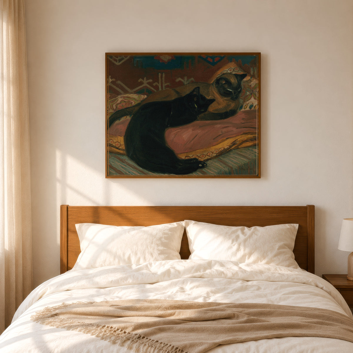 Framed art print of Deux chats couchés sur un canapé by Théophile Steinlen, in a slim wood frame above a bed in a sunlit bedroom
