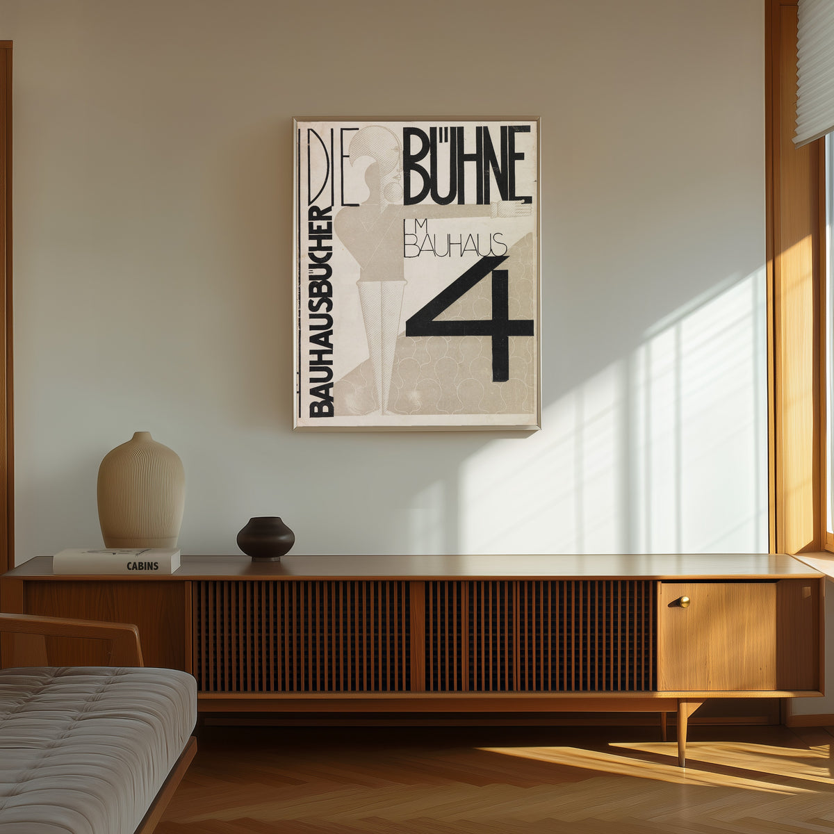 Framed art print of Die Bühne im Bauhaus by Oskar Schlemmer, in a thin light frame on a sunlit wall above a wooden sideboard