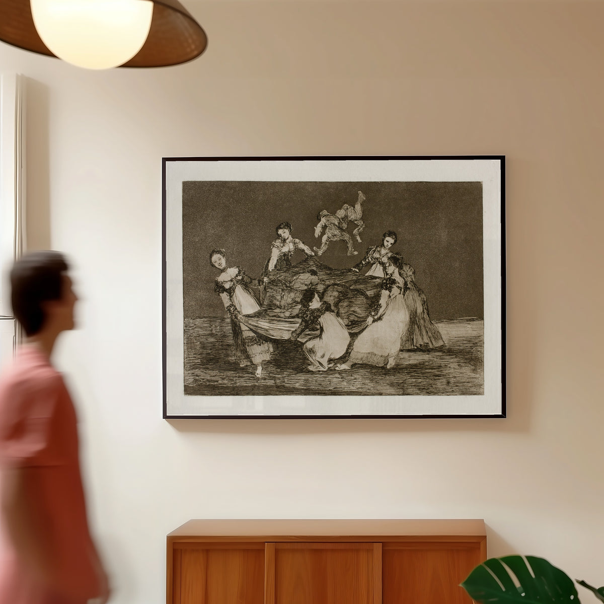 Framed art print of Disparate femenino (Feminine Folly), from Los Disparates by Francisco de Goya, in a slim black frame on a warm wall in a sunlit room