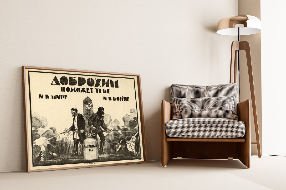 Framed art print of Dobrokhim Will Help You in Peace and in War, leaning against a wall beside an armchair and a floor lamp