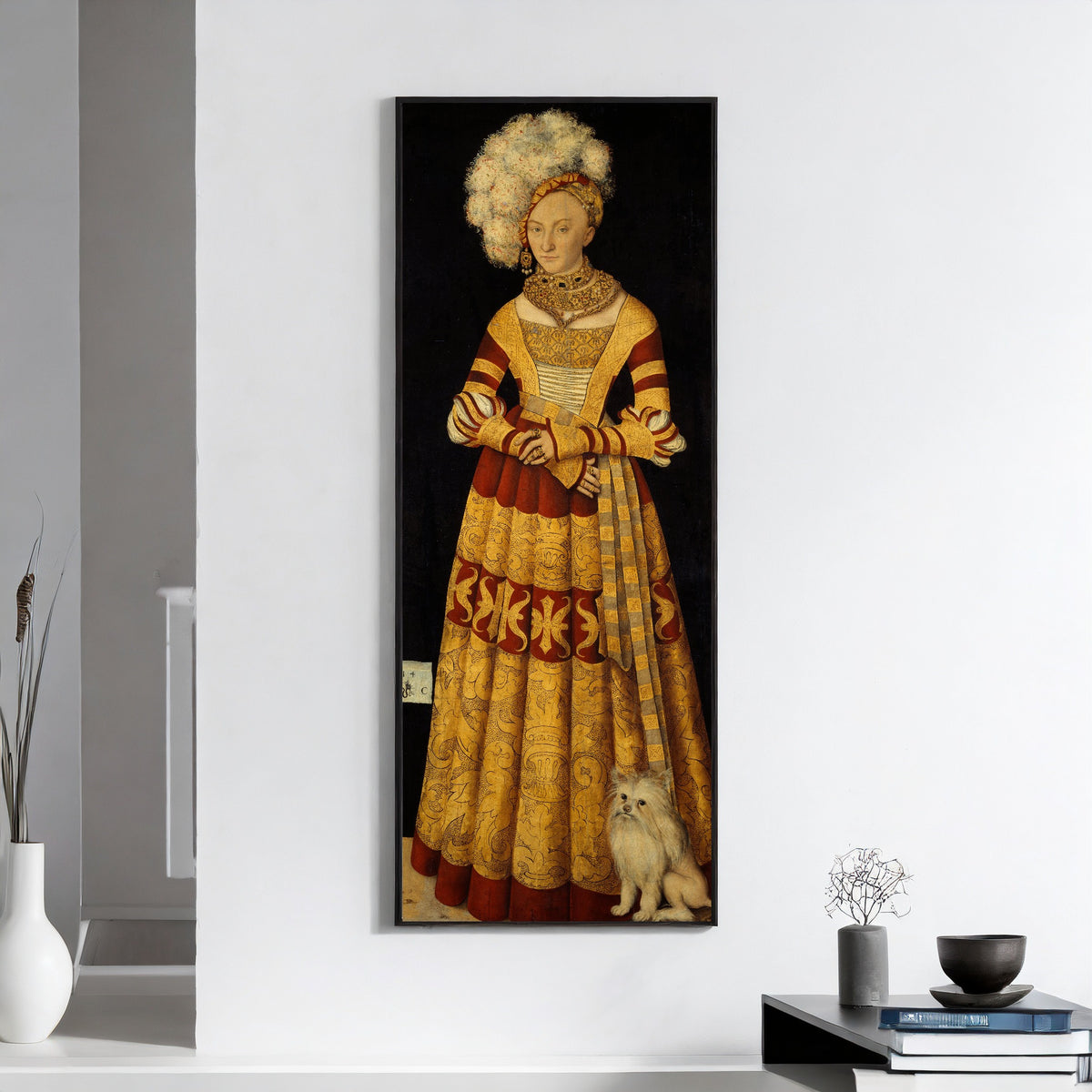 Framed art print of Duchess Katharina von Mecklenburg by Lucas Cranach the Elder, on a white wall above books and a bowl