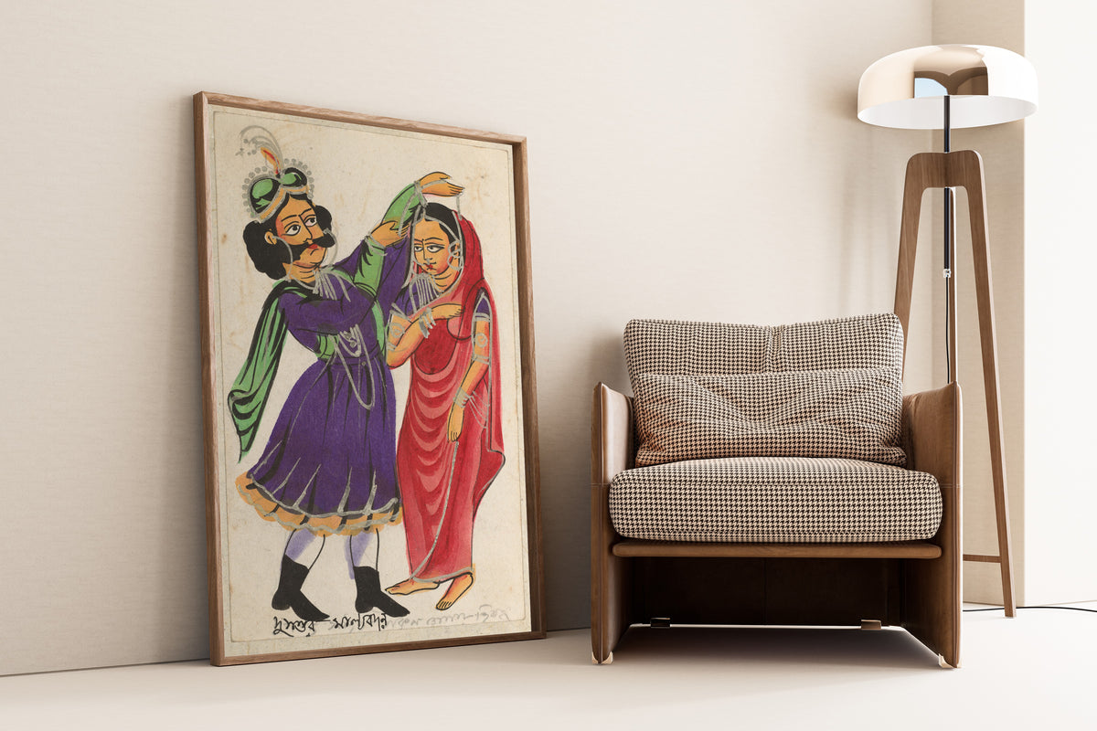 Framed art print of Dusmanta Garlanding Shakumtala by Kalighat painter, leaning against a wall beside an armchair and a floor lamp
