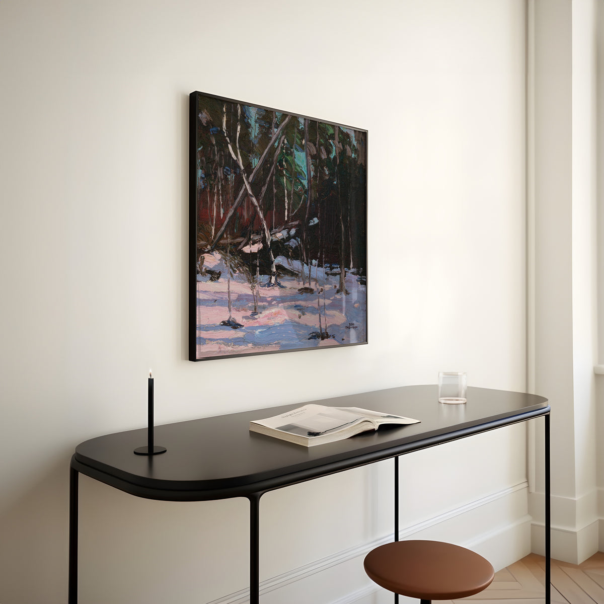 Framed art print of Early Snow, Algonquin Park by Tom Thomson, above a slim black console table