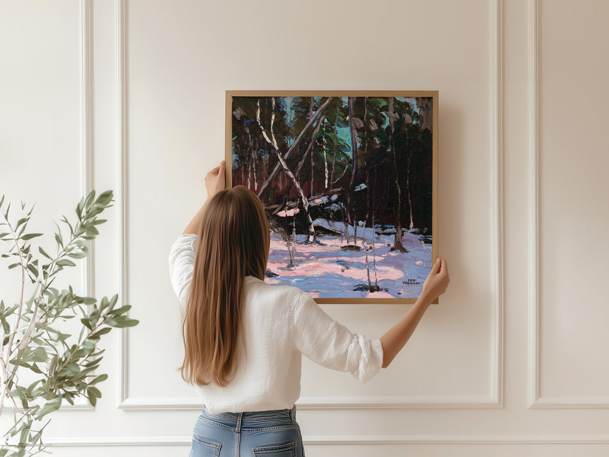 Framed art print of Early Snow, Algonquin Park by Tom Thomson, hung on a panelled wall