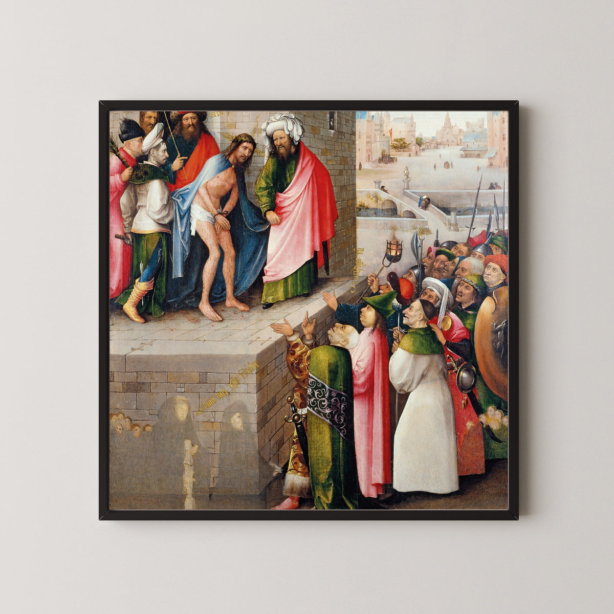 Framed art print of Ecce Homo by Hieronymus Bosch, in a black frame on a pale wall