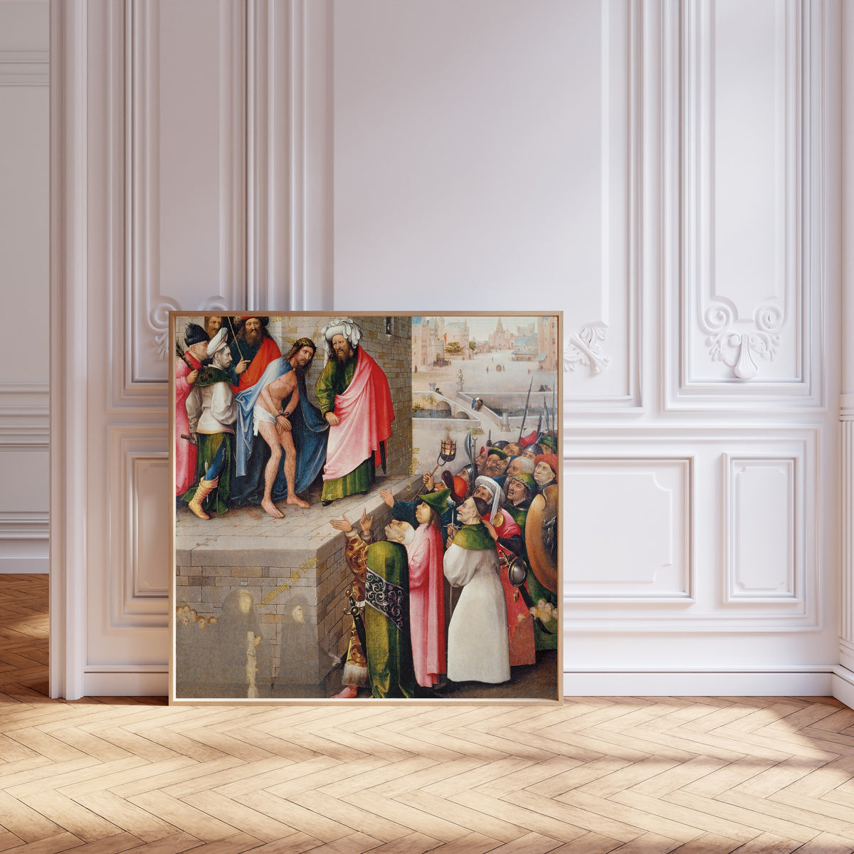 Framed art print of Ecce Homo by Hieronymus Bosch, leaning against pale pink panelling on a herringbone floor