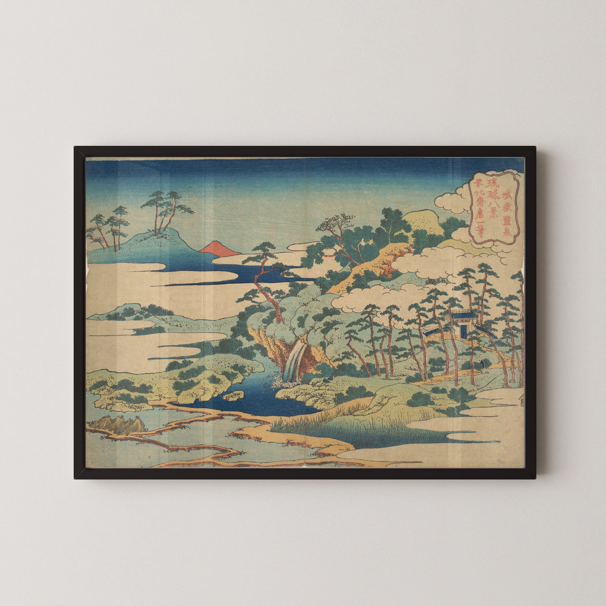 Framed art print of Eight Views of the Ryūkyū Islands: The Sacred Spring at Jōgaku by Katsushika Hokusai, in a black frame on a pale wall