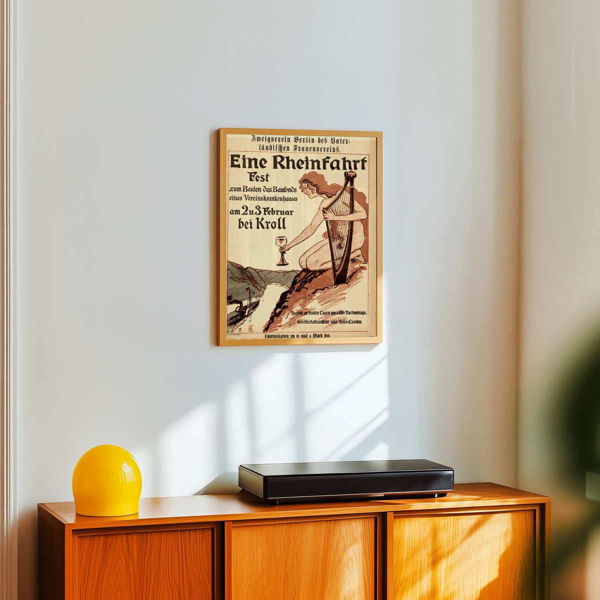 Framed art print of Eine Rheinfahrt: Zweigverein Berlin des Vaterländischen… by Otto Eckmann, in a light wood frame on a white wall above an orange sideboard
