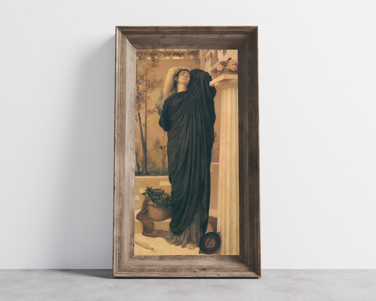 Framed art print of Electra at the Tomb of Agamemnon by Frederic Leighton, in a wide wooden frame leaning against a concrete wall