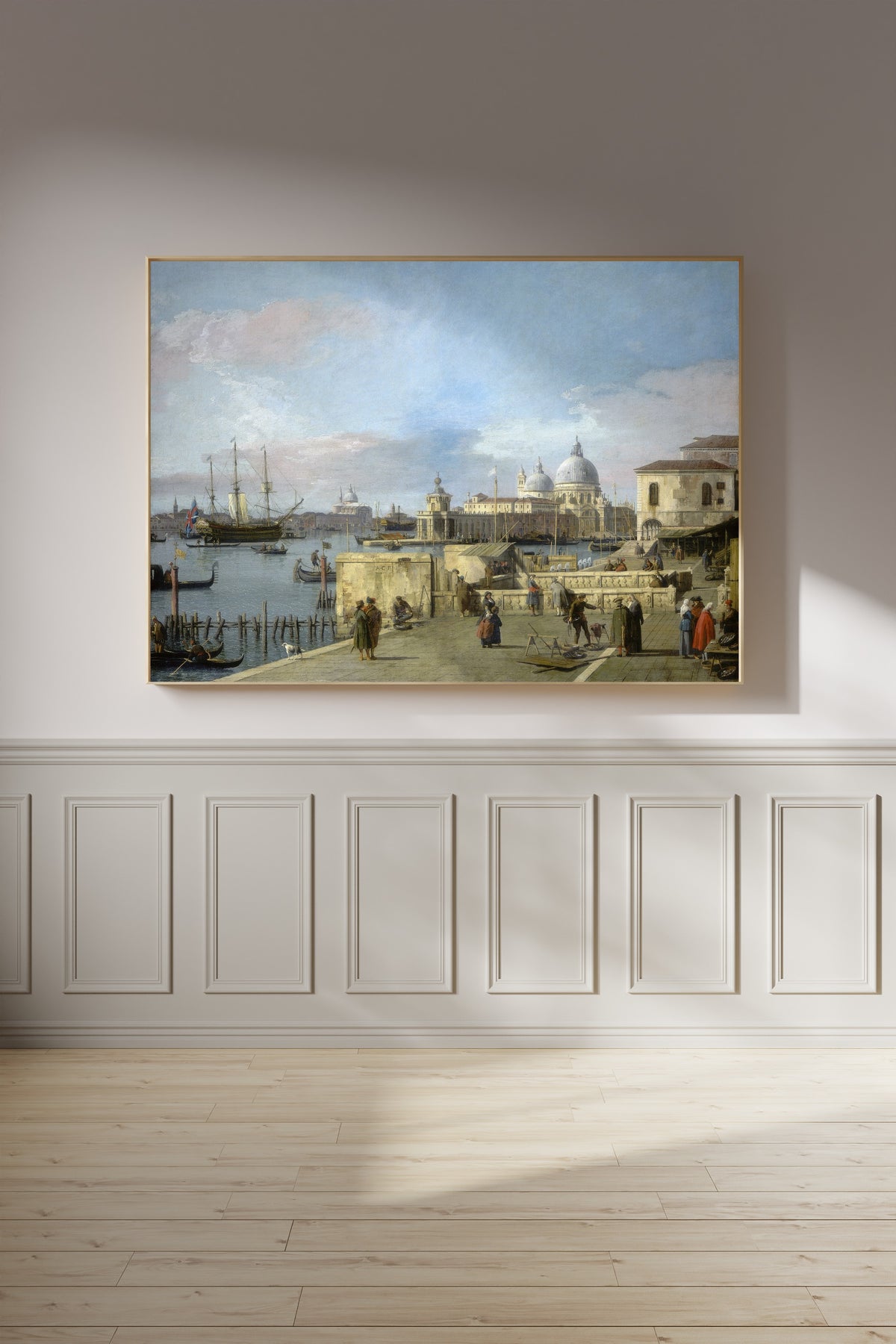 Framed art print of Entrance to the Grand Canal from the Molo, Venice by Canaletto, on a panelled wall in afternoon light