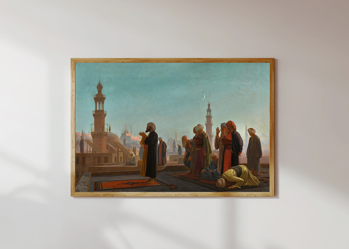 Framed art print of Evening Prayer, Cairo by Jean-Léon Gérôme, in a light wood frame on a sunlit white wall