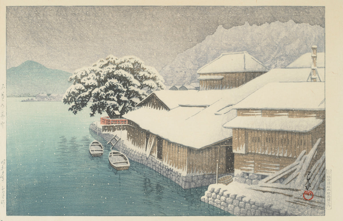 Evening Snow at Ishinomaki by Kawase Hasui — Snow-laden storehouses and moored boats on a teal inlet