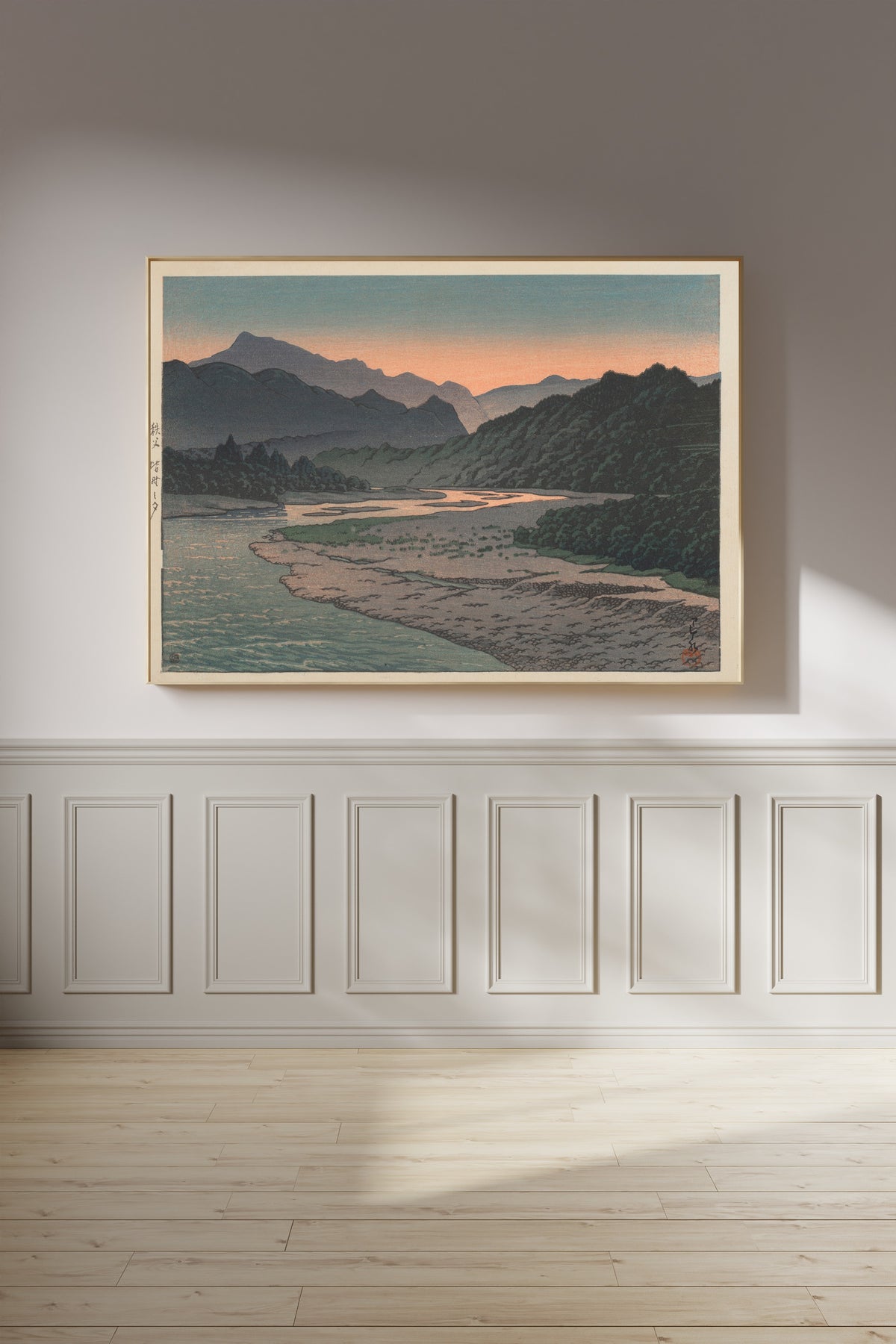 Framed art print of Evening at Minano, Chichibu by Kawase Hasui, on a panelled wall in afternoon light