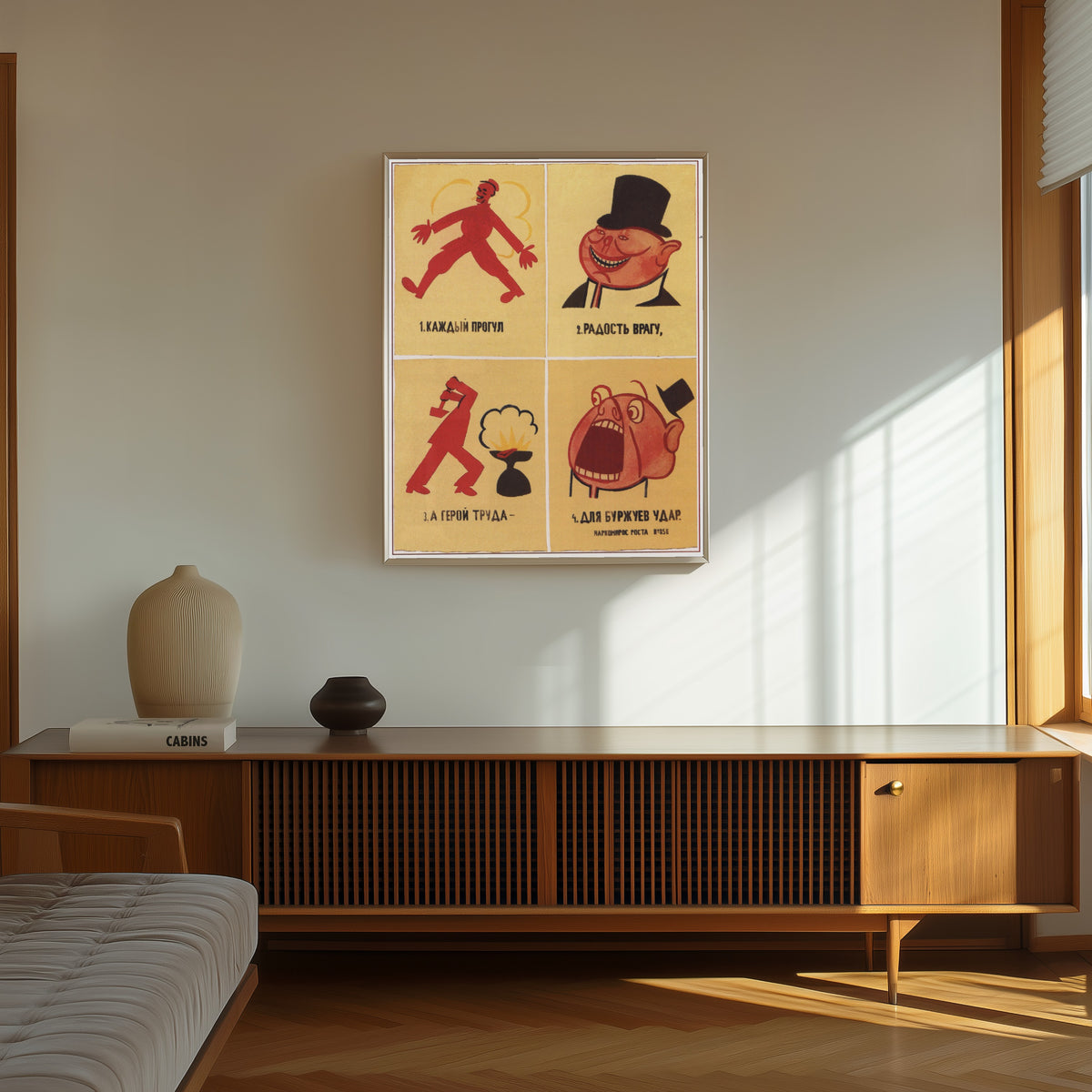 Framed art print of Every absence from work is a joy to the enemy; the… by Vladimir Mayakovsky, in a thin light frame on a sunlit wall above a wooden sideboard
