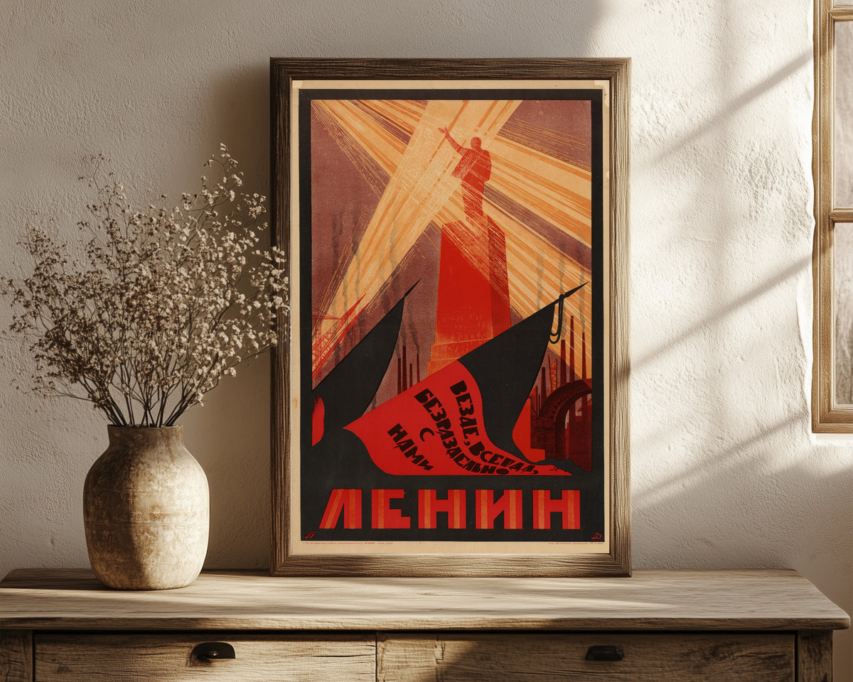Framed art print of Everywhere, always, inseparably with us is Lenin, in a dark wood frame leaning on a rustic console beside dried flowers