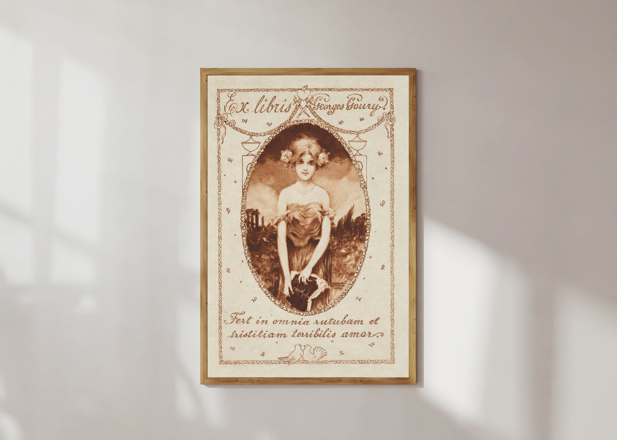 Framed art print of Ex Libris Georges Goury by Raphael Kirchner, in a light wood frame on a sunlit white wall